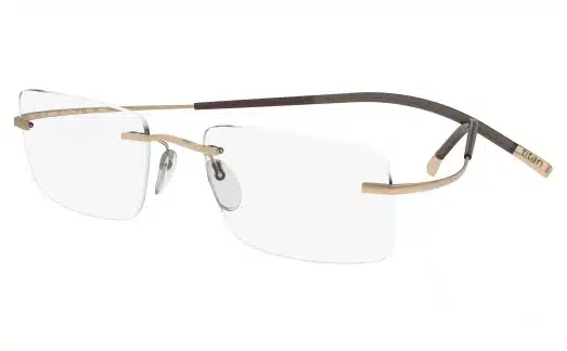 A pair Silhouette eyeglasses, rimless with gold and black temples.