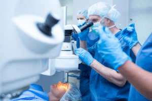 Healthcare professionals in blue scrubs examining a patient for LASIK eligibility.