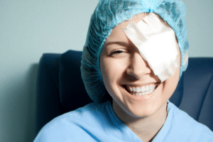 A woman with a bandage over her eye, undergoing post-LASIK recovery.