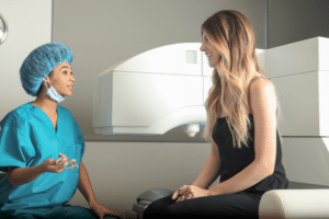 Female healthcare professionals in scrubs conversing in a hospital preparing for LASIK surgery.