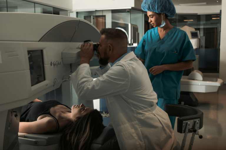 A woman reclines on a table, preparing for a LASIK eye surgery procedure in a clinical setting.