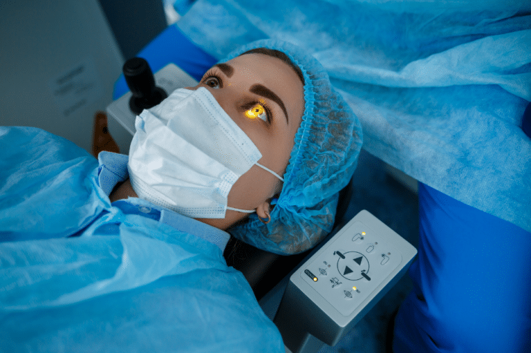 : A woman dressed in a blue hospital gown and mask lies on a bed, representing her being a good patient for LASIK candidacy.