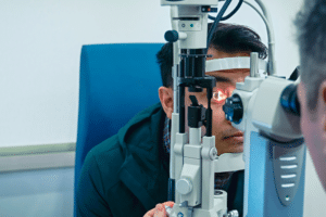 A man attentively participating in an eye exam, preparing for LASIK screening.