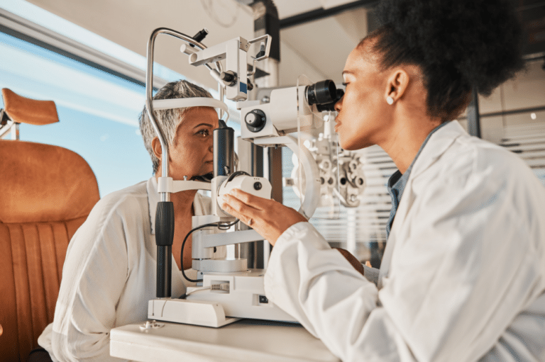 A woman interacts with an eye exam machine, highlighting the importance of primary eye care for vision assessment.
