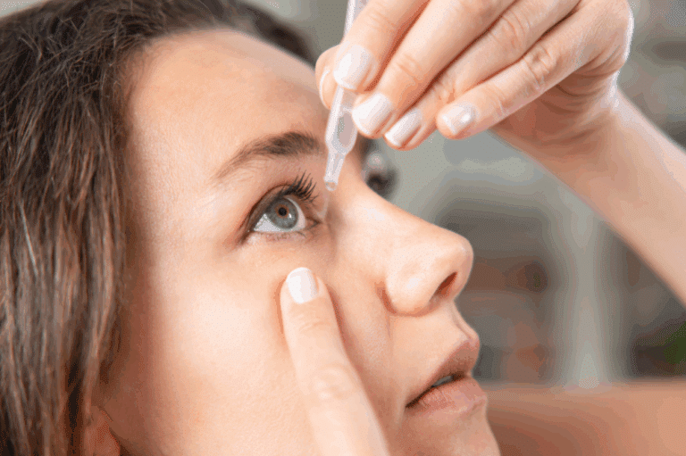 A woman applying artificial tears eye drops to her eyes for relief.