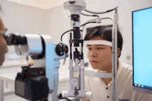 A man focused on an eye exam, emphasizing the need for regular eye exams to maintain good vision.