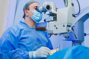 A healthcare professional in blue scrubs performs a surgery for a LASIK vs PRK comparison.
